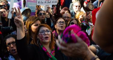 Frauen und Männer demonstrieren demonstrieren mit Bannern, Halstüchern und Pfannen