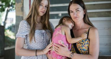 Nadiia mit ihren beiden Töchtern Anastasiia* und Melisa*. Die drei sind aus der Ukraine nach Rumänien geflohen und haben sich gerade vom eLiberare-Team dazu beraten lassen, wie sie sich auf ihrer weiteren Reise vor Menschenhandel schützen können. Nadiia mit ihren beiden Töchtern Anastasiia* und Melisa*. Mutter Nadiia hält ihre kleinere, schlafende Tochter Anastasiia* auf dem Arm. Die drei sind aus der Ukraine nach Rumänien geflohen und haben sich gerade vom eLiberare-Team dazu beraten lassen, wie sie sich auf ihrer weiteren Reise vor Menschenhandel schützen können.
