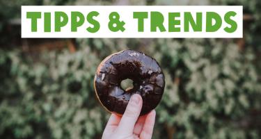 Hand hält einen Donut, Überschrift: Tipps und Trends